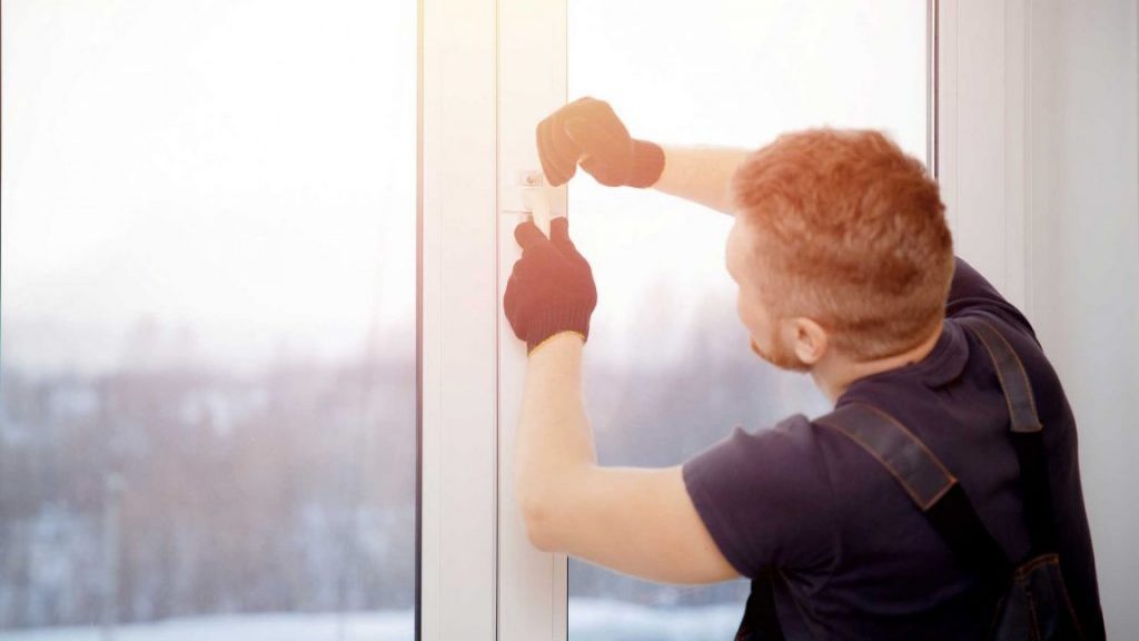 Tradesman servicing a uPVC window mechanism in Wishaw