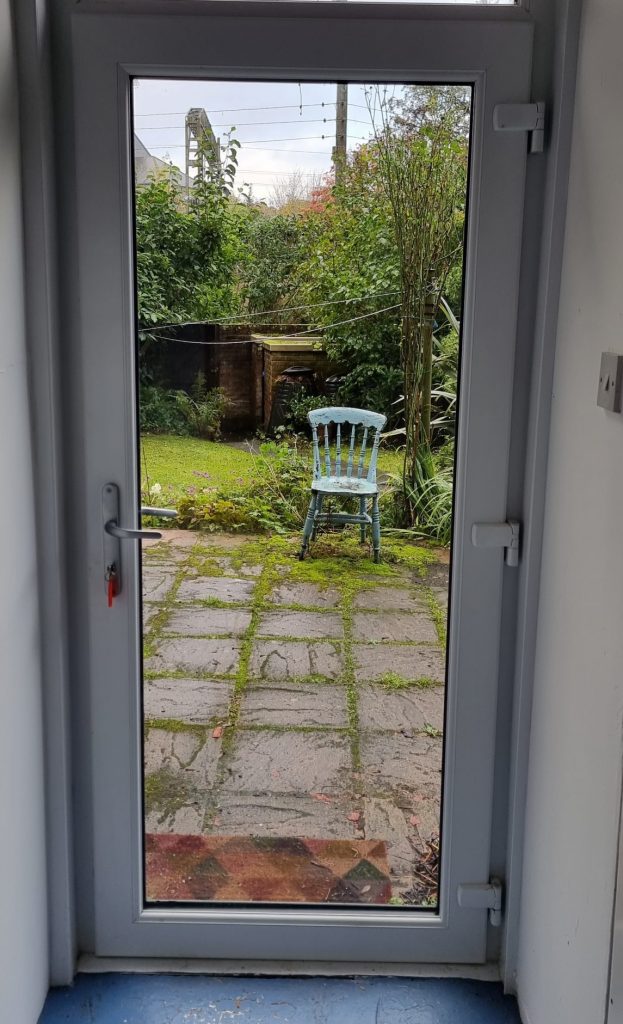 uPVC French doors open onto a garden before the door gear was repaired