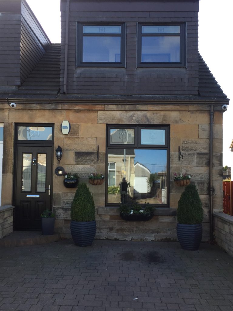 New anthracite grey window and composite front door on the same sandstone house