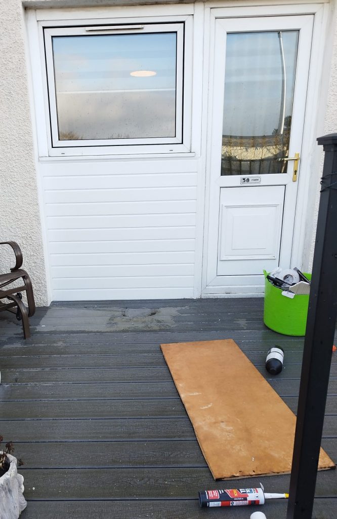The same doorway with a new white uPVC panel fitted in place of the old timber