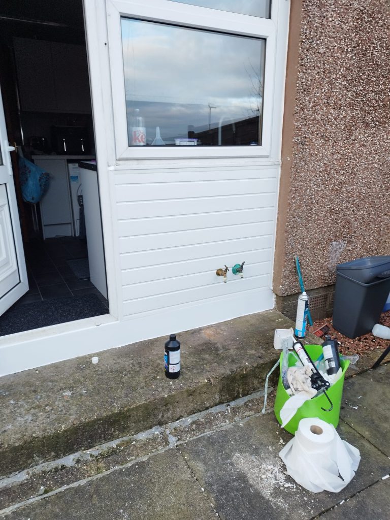 A new white uPVC door panel fitted, with the door open and the job finished