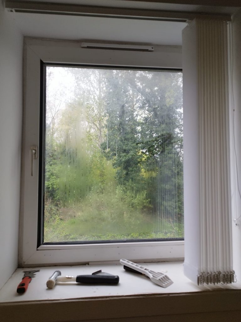 Misted double glazing blurring the trees outside a Lanarkshire home