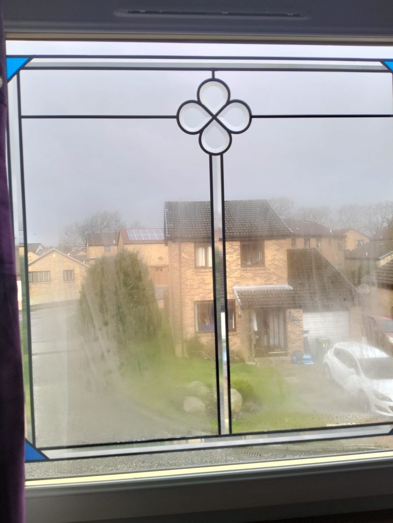 Badly misted sealed unit with the houses opposite barely visible through the fog