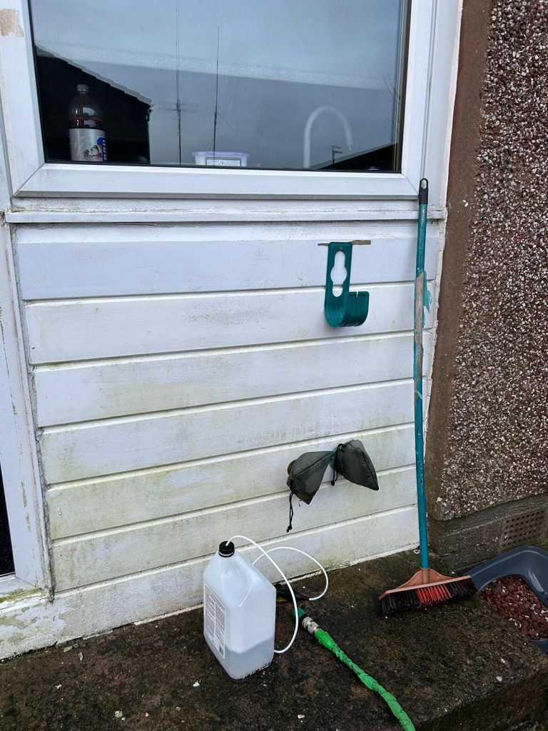 Algae stained white uPVC door panel before it was replaced