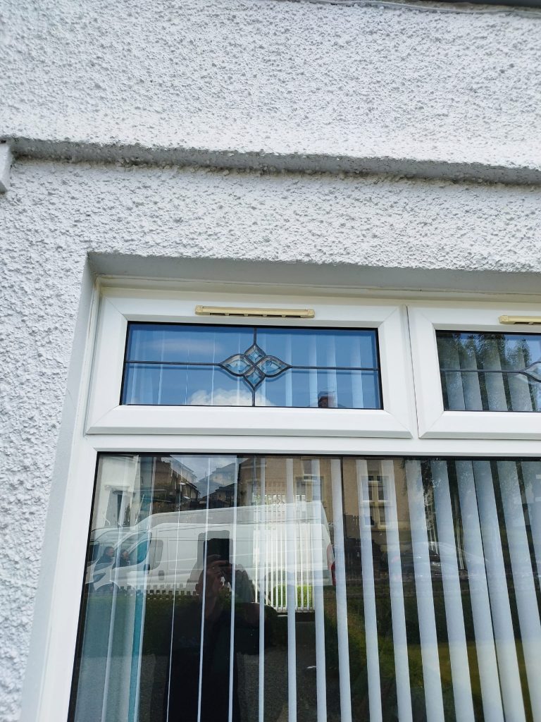 White uPVC window with a leaded top opener before the unit was replaced